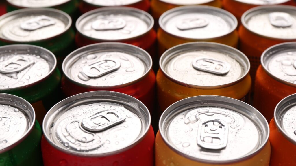 Many multi-colored cans arranged in rows.