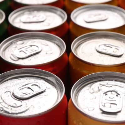 Many multi-colored cans arranged in rows.